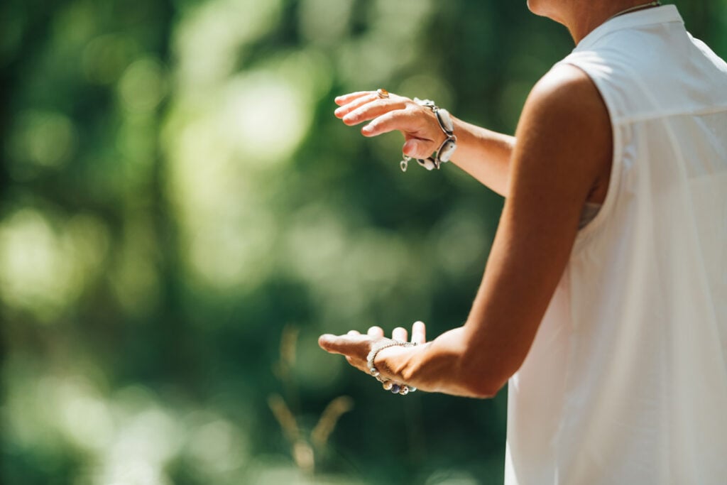 Mature woman exercising Tai Chi in nature