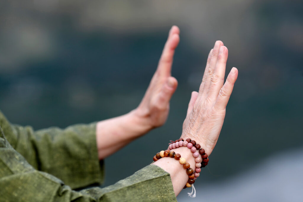 Woman practicing Qi Gong or Tai Chi exercise in nature
